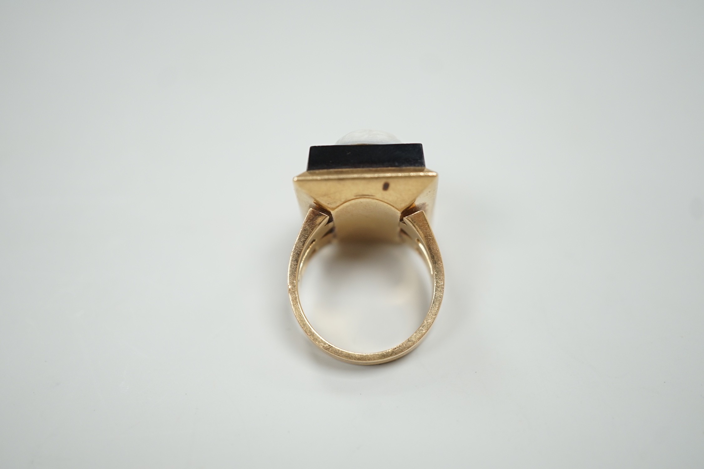 A yellow metal and black sardonyx set rectangular cameo ring, carved with the bust of a gentleman to sinister, size L, gross weight 12.6 grams.